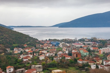 Fototapeta na wymiar Mediterranean landscape on a cloudy winter day. Montenegro, view of Bay of Kotor and seaside Zelenika town