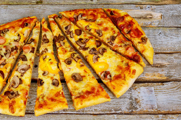 Pizza is delicious on the wooden table.
