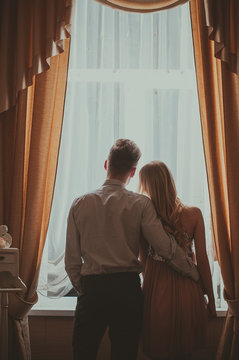 Young Couple Looking Out The Window