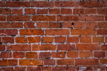 Old vintage brick wall with the remains of paint - grunge texture, background