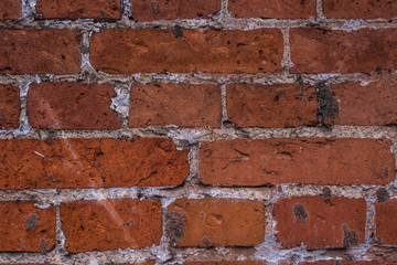 Old vintage brick wall with the remains of paint - grunge texture, background