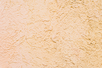 Rough concrete wall painted in beige color - background, texture