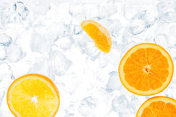 Juicy oranges on ice cubes background with copy space.