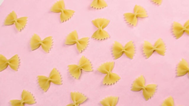 Pasta on pink pastel surface close up macro.
