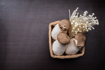 Fototapeta na wymiar Mushroom in The basket weave on wood background.
