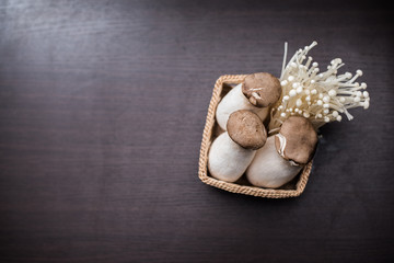 Mushroom in The basket weave on wood background.