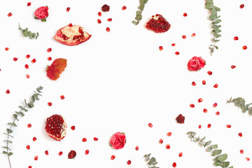 Stylish background with pomegranate and eucalyptus branches, white background, copyspace