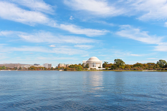 Washington DC panorama in autumn with Thomas Jefferson Memorial and Capitol Hill on horizon. Tidal Basin landscape in the fall under high cloudy skies.