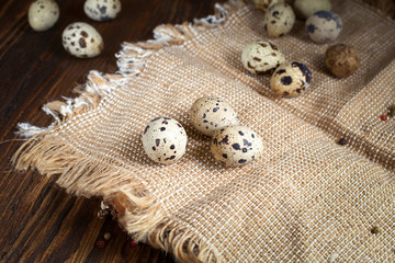Fototapeta na wymiar quail eggs on a napkin on a wooden table
