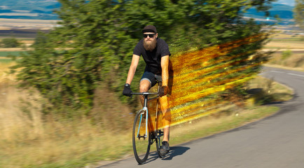 Naklejka premium Young riding bicycle in nature