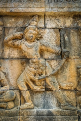 Figure of a female archer carved on the wall in the Borobudur temple