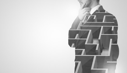 Businessman standing and thinking  with maze