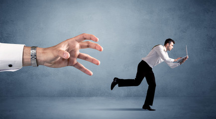 Businessman running from hand