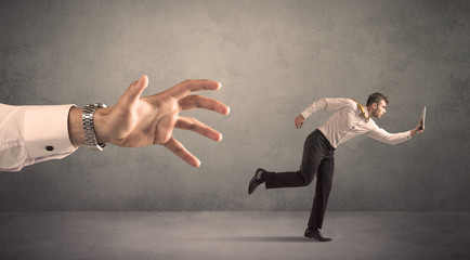Businessman running from hand