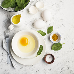 Ingredients for scrambled eggs with spinach and turmeric on the background. Top view. Copy space.