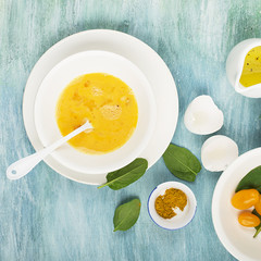 Ingredients for scrambled eggs with spinach and turmeric on the background. Top view. Copy space.