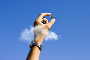 Hand grabing on to an airplane illusion.