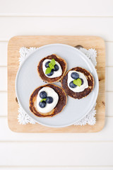 Healthy pancakes with white yogurt, blueberries and agava syrup