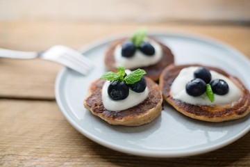 Healthy pancakes with white yogurt, blueberries and agava syrup