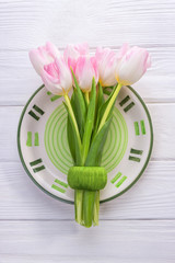 Beautiful pink tulips on a white background. Top view, free space