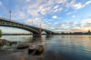 Beautiful sunset over Rhine / Rhein river and old bridge in Mainz near Frankfurt am Main, Germany.
