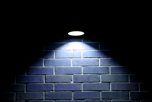 Blue Light Shining On Brick Wall