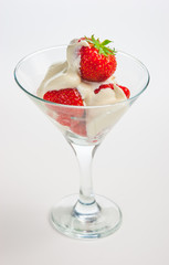 strawberries and cream in a glass on a white background