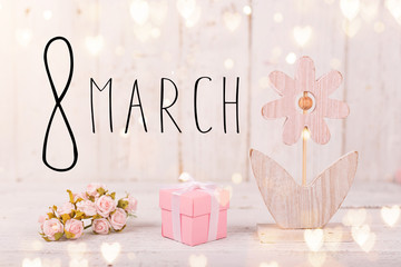 Flowers composition for Women's Day. Pink flowers on old white wooden background.