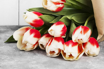 Bouquet of white pink tulips on a gray background