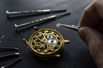 Watchmaker is repairing the mechanical watches in his workshop