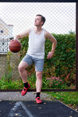 attractive man holding basketball and looking away