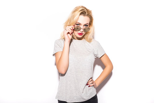 Young blond woman with sunglasses on white background