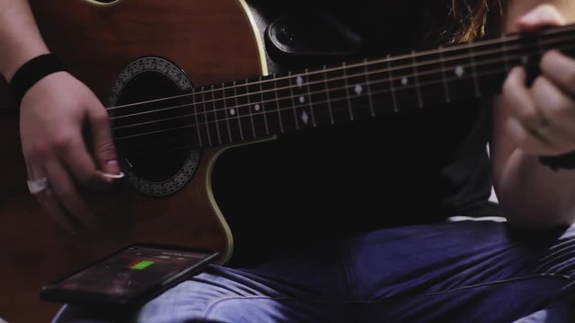 musician play on electro acoustic guitar in studio