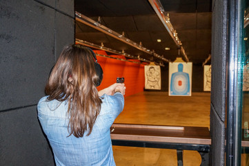 girl shooting gun at range