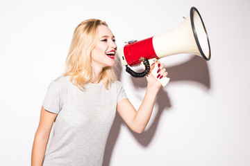 beautiful shocked woman screaming into megaphone, isolated on white