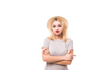 Closeup studio portrait of joyful hipster young smiling woman in hat with crossed hands isolated on white background