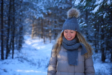 portrait of a beautiful girl close-up on a winter forest background in the snow