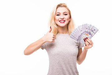 Portrait of a cheerful girl covering her eye with dollar bills and showing thumb up isolated on a white background