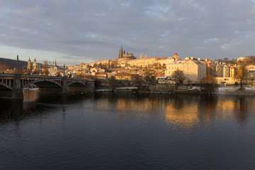 Snowy Prague Lesser Town with gothic Castle in the rising sun, Czech republic