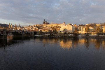 Snowy Prague Lesser Town with gothic Castle in the rising sun, Czech republic