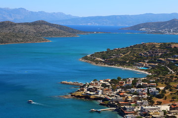 Fototapeta na wymiar Part of the eastern cretan coast (Greece) near Elounda, panorama of part of the city and the ocean in Crete.