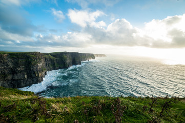 The Cliffs of Moher, Irelands Most Visited Natural Tourist Attraction, are sea cliffs located at the southwestern edge of the Burren region in County Clare, Ireland.