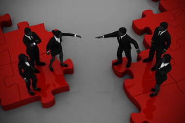 Two teams Merging on a jigsaw puzzle.
Two teams of executives merging on a jigsaw puzzle showing a partnership and collaboration.