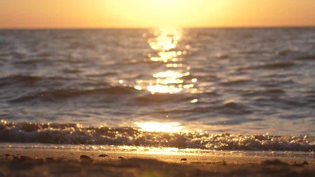 Sand and waves on beautiful sunset beach. slow motion. 1920x1080