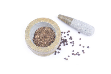 Black peppercorns in stone mortar isolated on white background