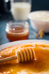Fresh pancakes with honey, maple syrup, cottage cheese and tangerines. Wooden background. Top view