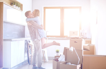 Portrait of young couple moving in new home. Young couple