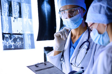 Two female women medical doctors looking at x-rays in a hospital.