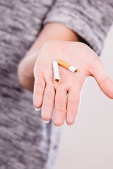 Closeup of broken cigarette on male hand.