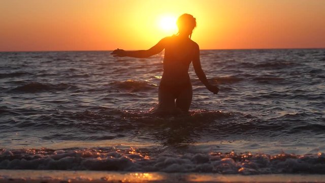 Young woman is running out of the sea free during holidays vacation travel. Summer woman beach freedom happy concept. slow motion. 1920x1080
